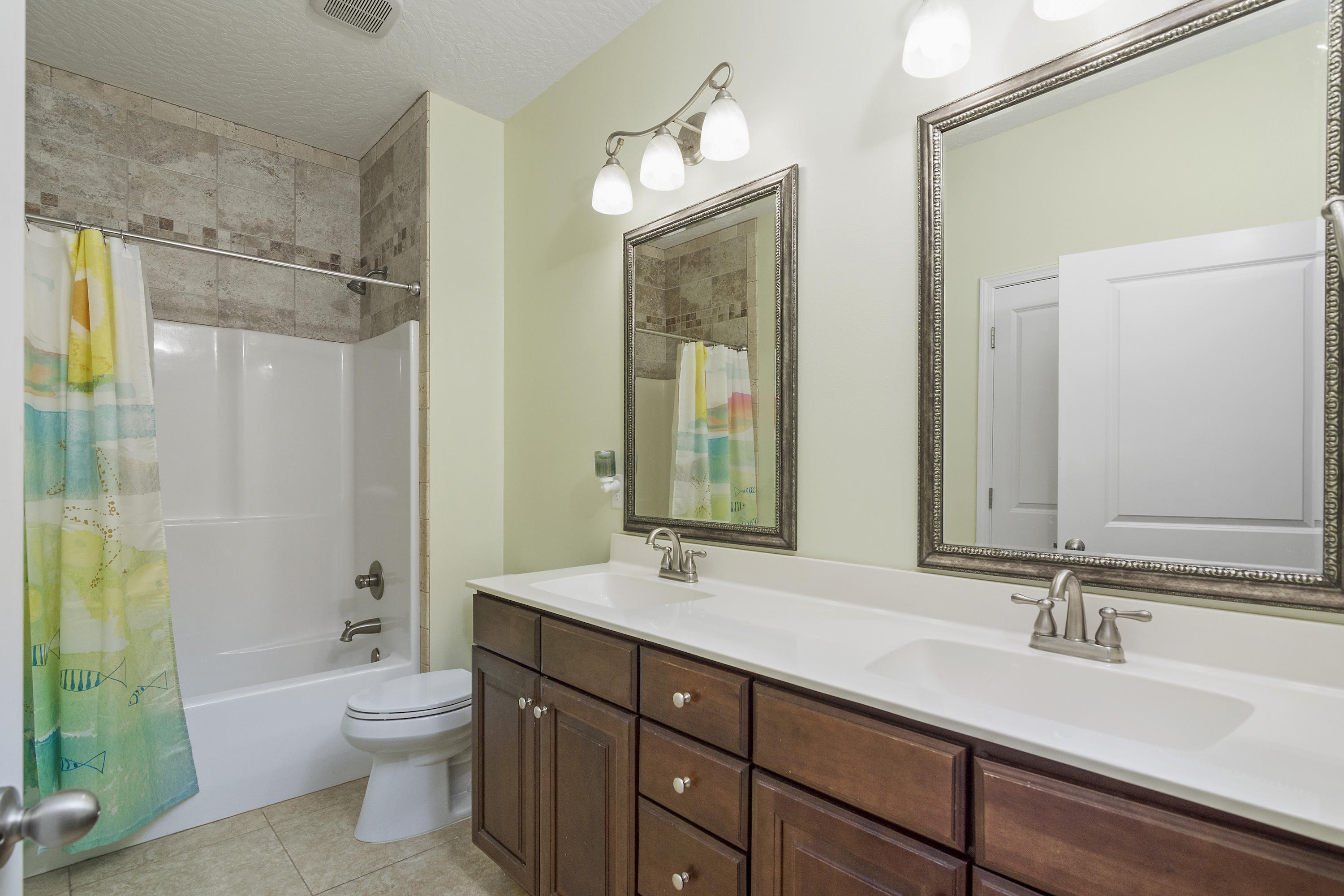 4605 Hermosa Road Crestview, FL 32539 - Photo 35 of 46 a bathroom with a double vanity sink toilet and shower