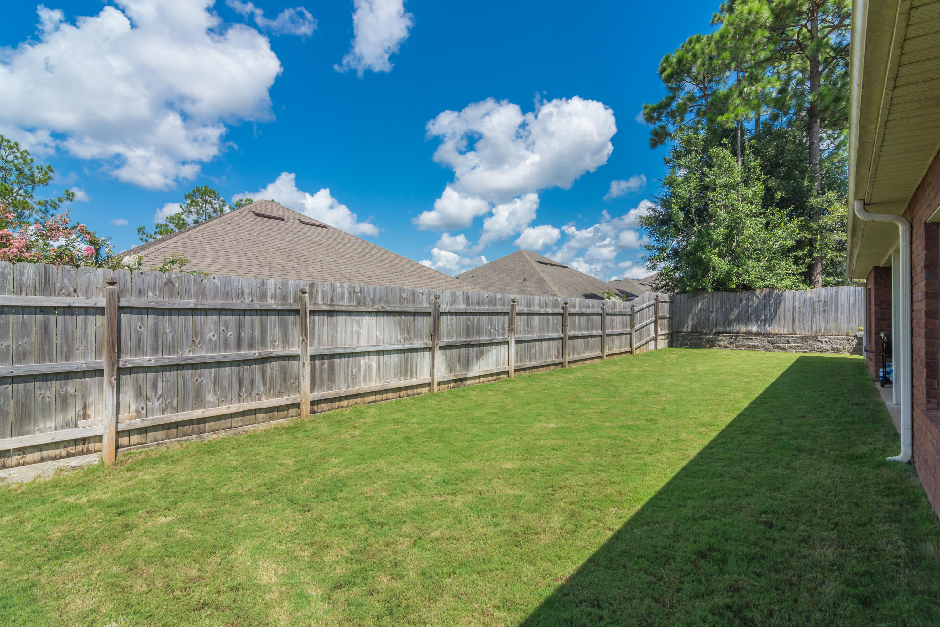 4605 Hermosa Road Crestview, FL 32539 - Photo 7 of 46 a view of a backyard with a garden