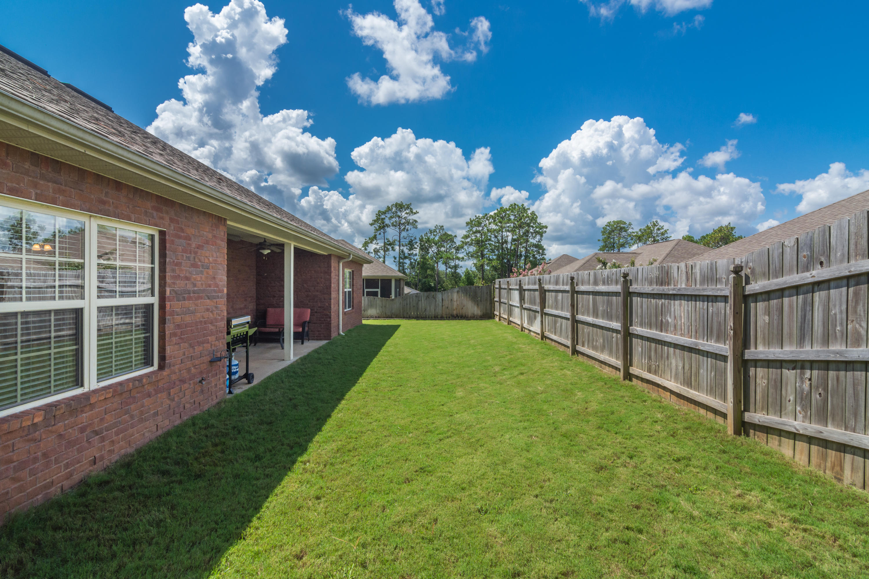 4605 Hermosa Road Crestview, FL 32539 - Photo 10 of 46 a view of a house with backyard and porch