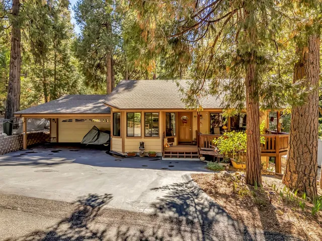 a view of a house with a yard and sitting area