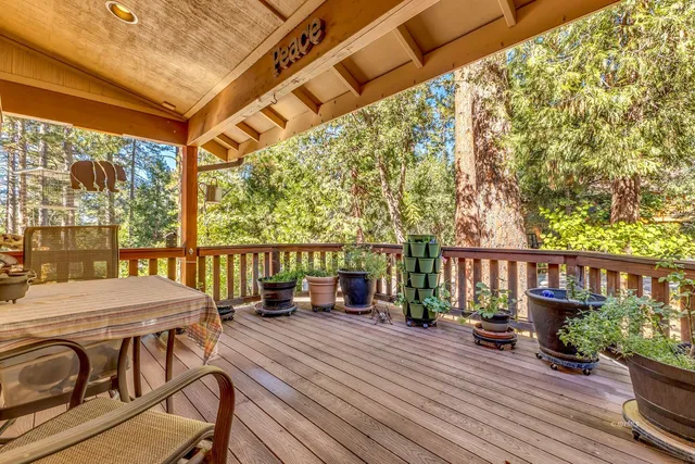 a living room with patio furniture and a flat screen tv