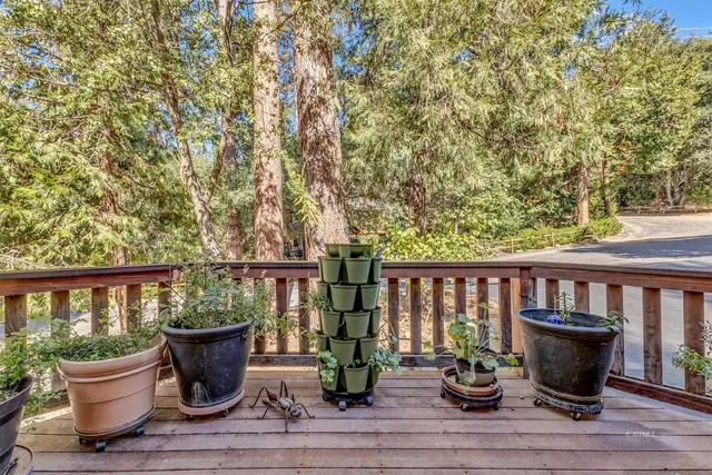 a living room with furniture a flat screen tv and a floor to ceiling window