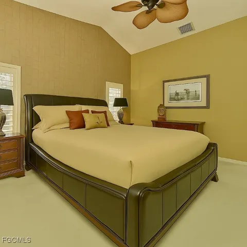 a bed sitting in a bedroom next to a lamp