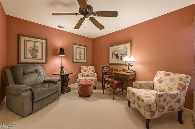a living room with furniture and a ceiling fan