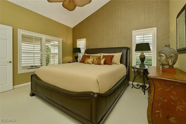 a bed sitting in a bedroom next to a window