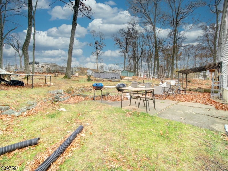 221 Chincopee Avenue Hopatcong, NJ 07843 - Photo 20 of 20 a swimming pool with outdoor seating and yard