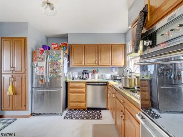 a kitchen with granite countertop a refrigerator and a sink