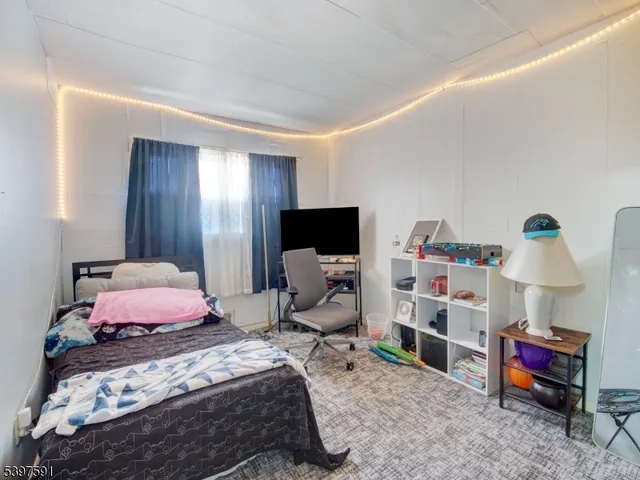 a bedroom with a bed and a tv