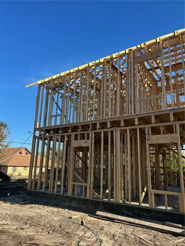 a view of a house with wooden fence