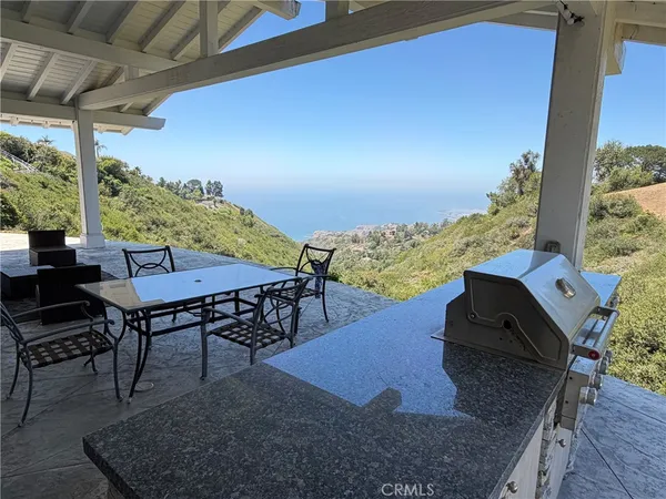 a view of a chairs and table in patio