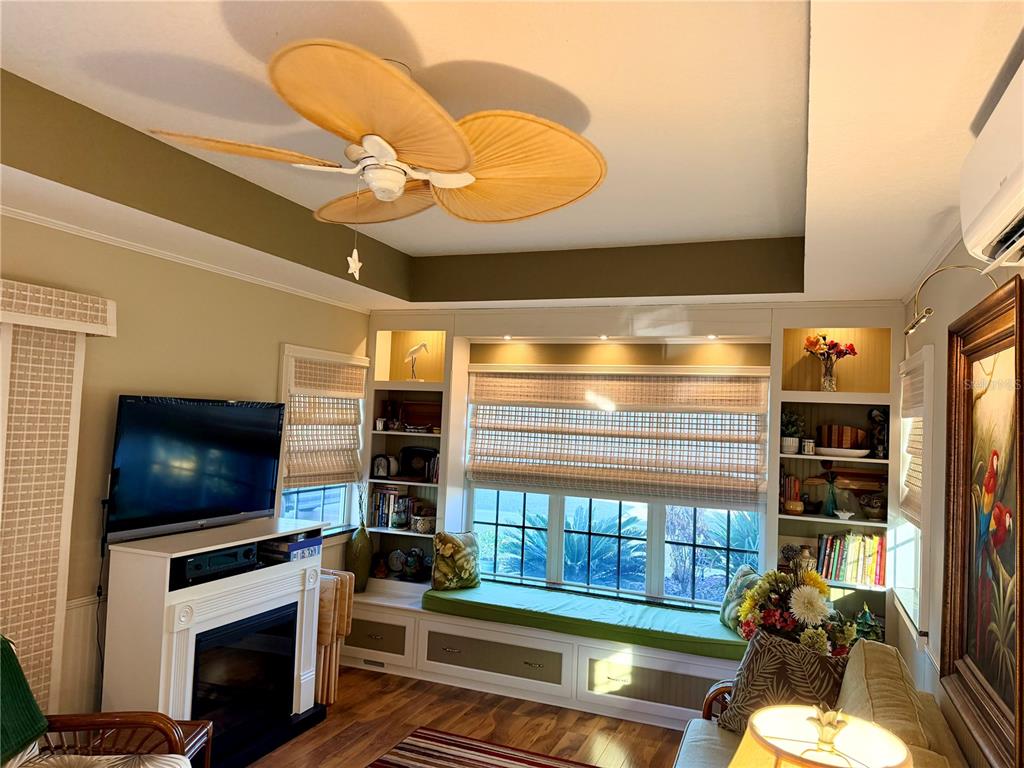 9564 Southeast 47th Way Webster, FL 33597 - Photo 13 of 40 a living room with fireplace furniture and a flat screen tv