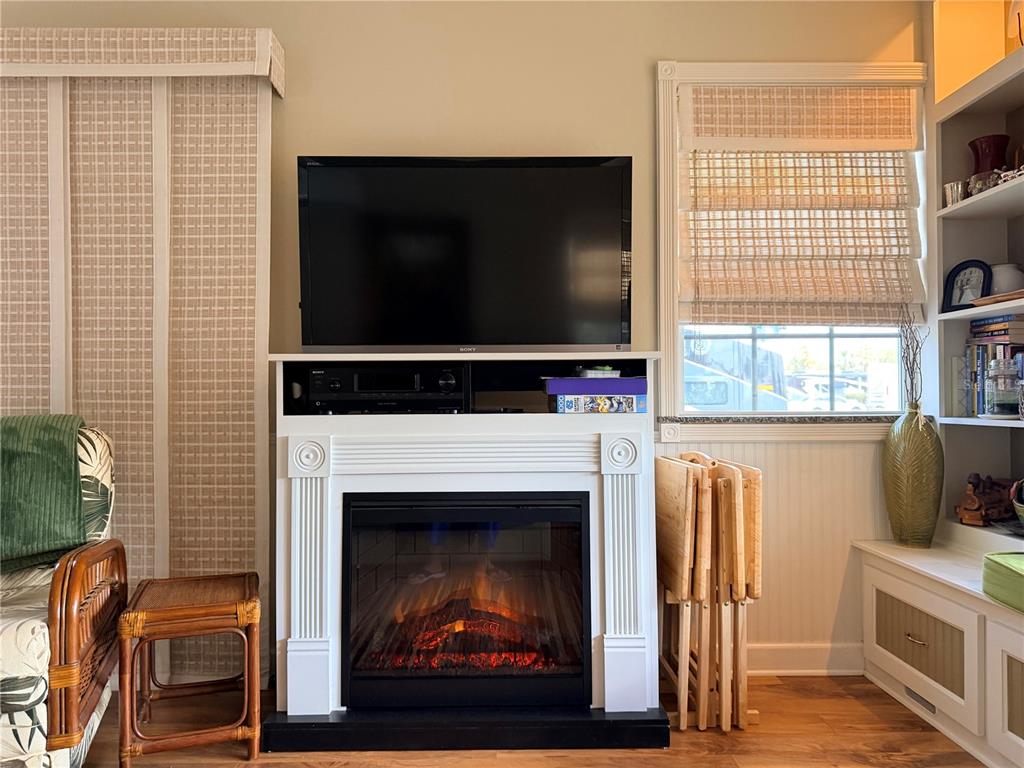9564 Southeast 47th Way Webster, FL 33597 - Photo 19 of 40 a living room with a fireplace and a flat screen tv