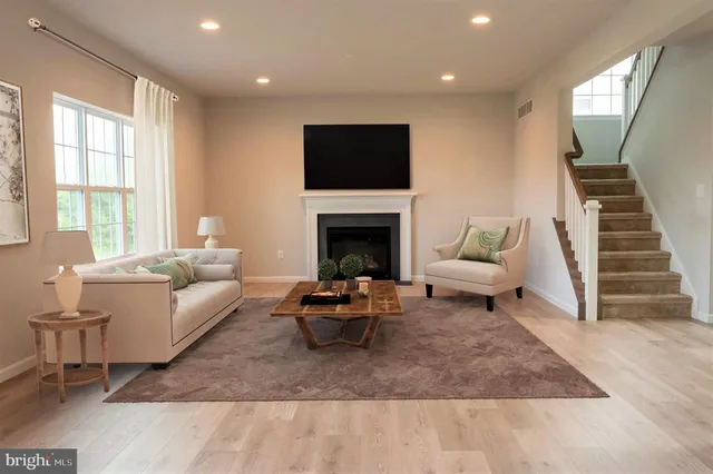 a kitchen with white cabinets stainless steel appliances and wooden floor