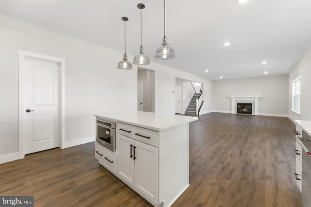 a kitchen with white cabinets and appliances
