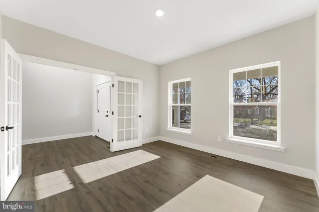 an empty room with windows and closet