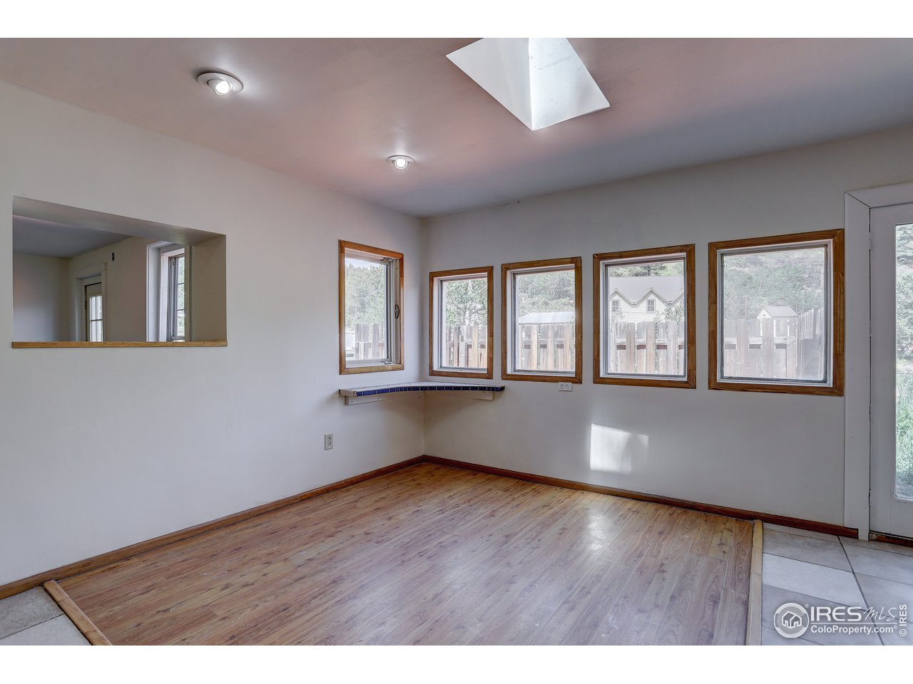 35 Boston Street Ward, CO 80481 - Photo 14 of 34 an empty room with wooden floor and windows