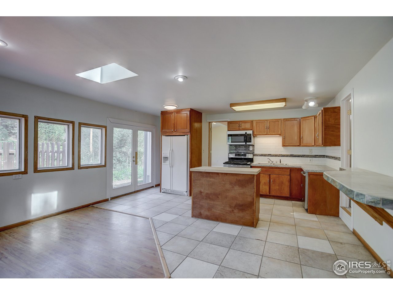 35 Boston Street Ward, CO 80481 - Photo 16 of 34 a kitchen with stainless steel appliances granite countertop a stove a sink and a refrigerator