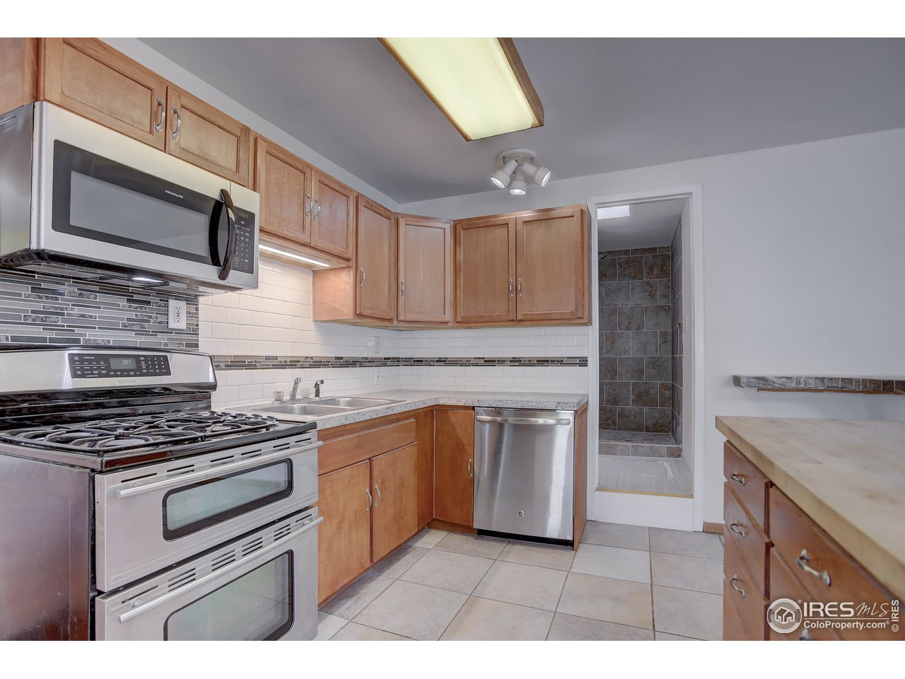 35 Boston Street Ward, CO 80481 - Photo 17 of 34 a kitchen with stainless steel appliances granite countertop a stove microwave and sink