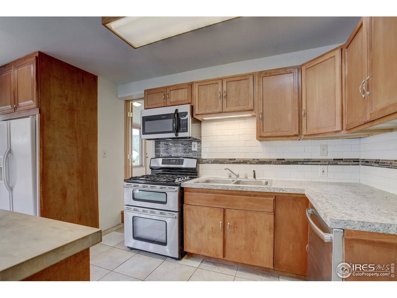 35 Boston Street Ward, CO 80481 - Photo 18 of 34 a kitchen with a sink a stove and cabinets