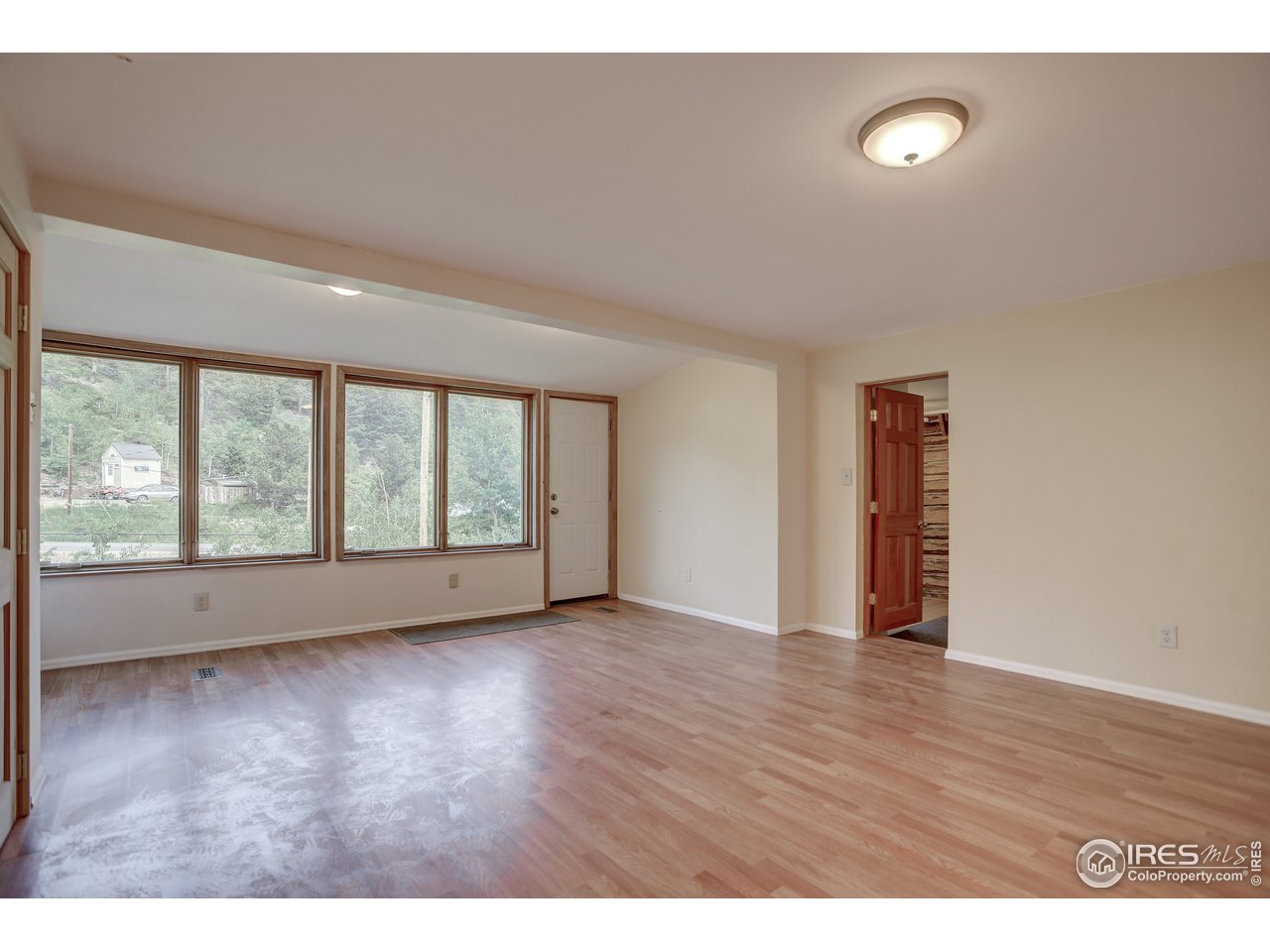 35 Boston Street Ward, CO 80481 - Photo 23 of 34 a view of an empty room with a window and wooden floor