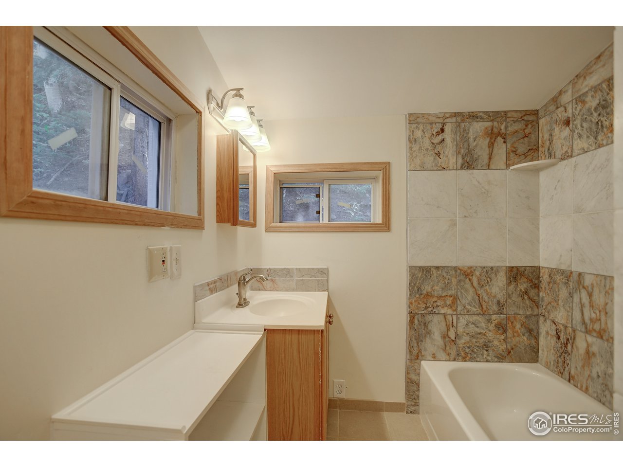 35 Boston Street Ward, CO 80481 - Photo 27 of 34 a bathroom with a sink mirror and a bathtub