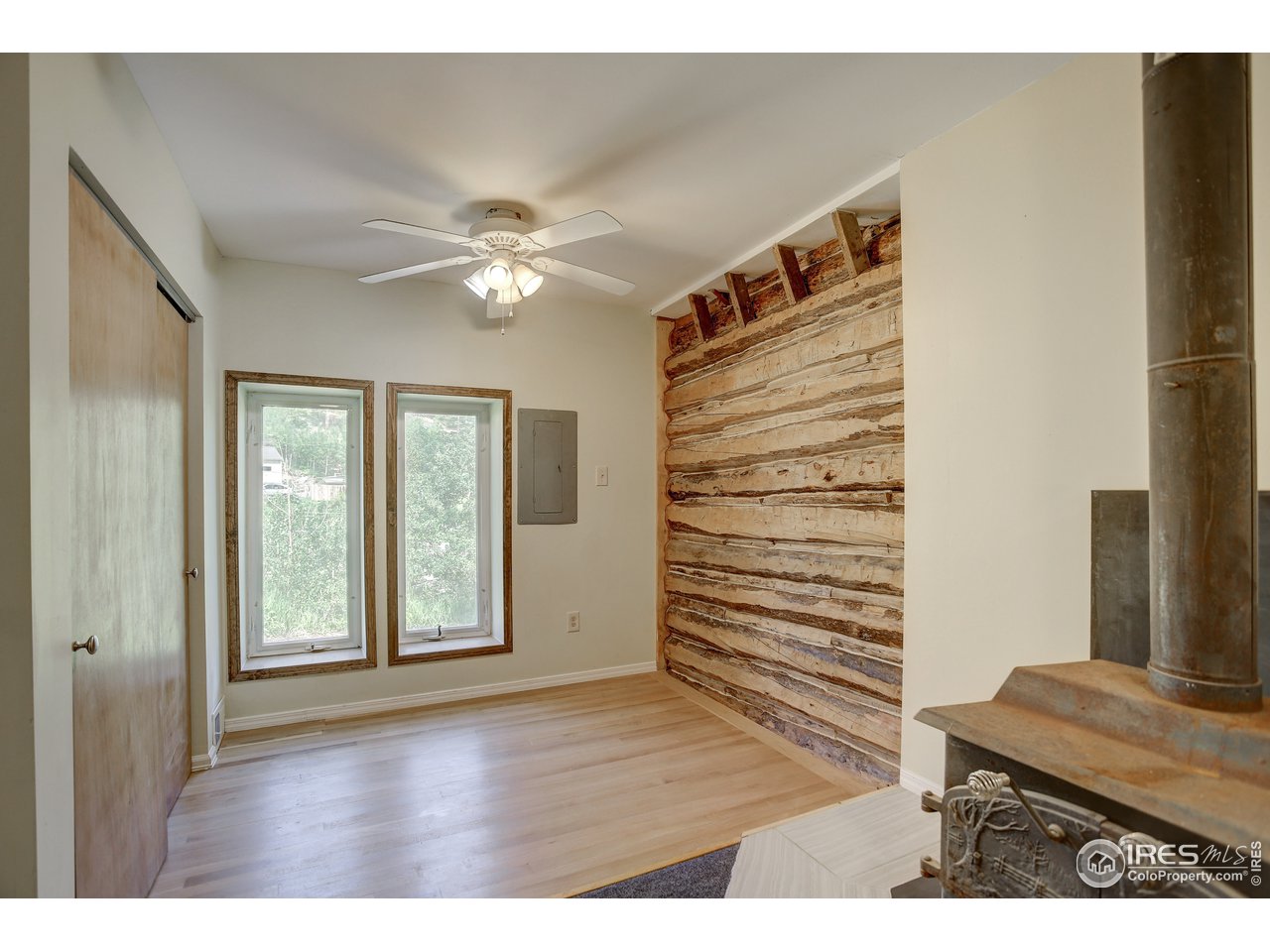 35 Boston Street Ward, CO 80481 - Photo 33 of 34 a view interior of a house with wooden floor a ceiling fan and windows