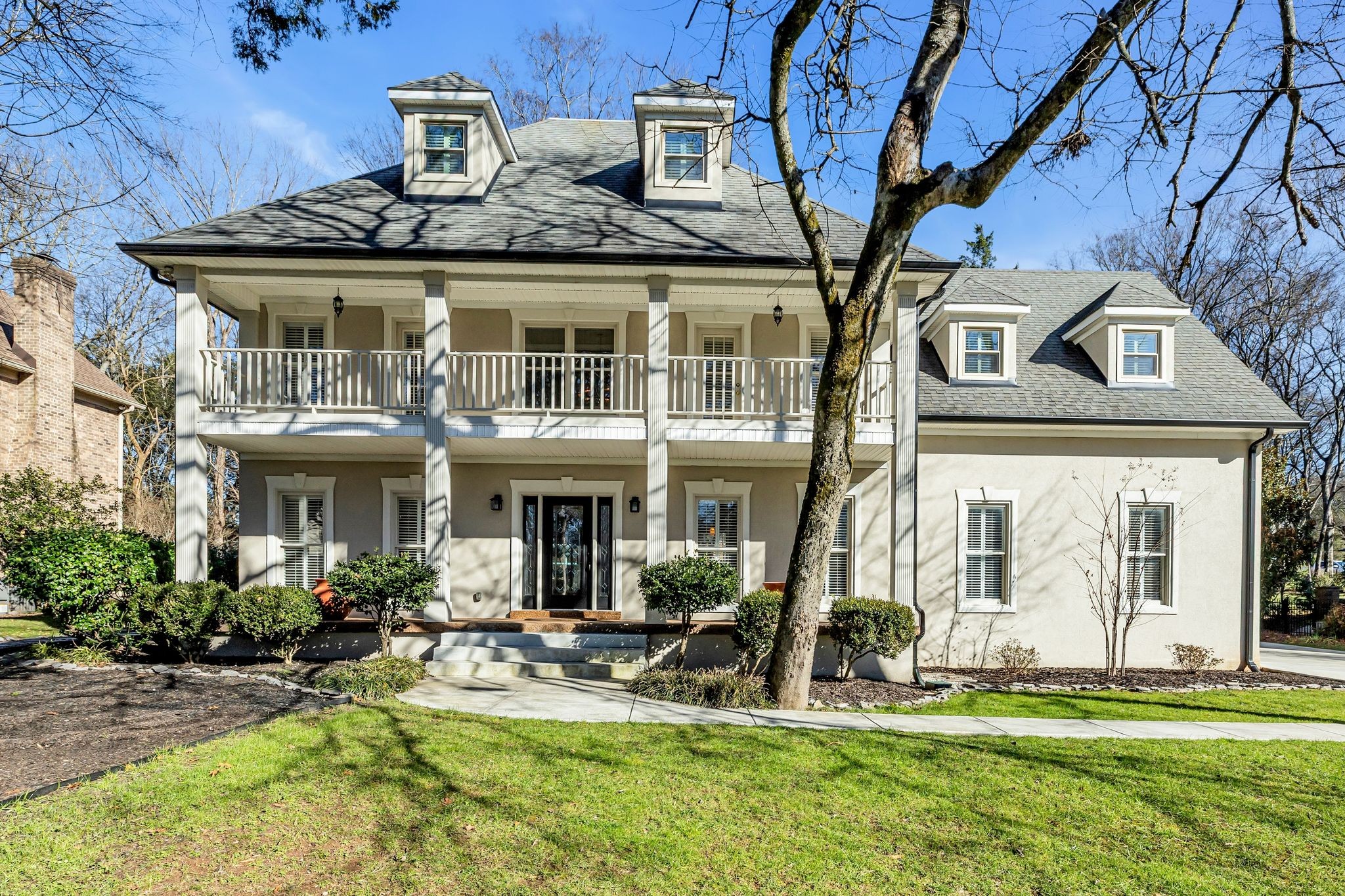 a front view of a house with swimming pool and porch
