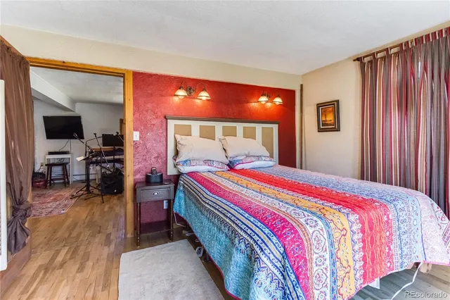 a bed sitting in a bedroom next to a window