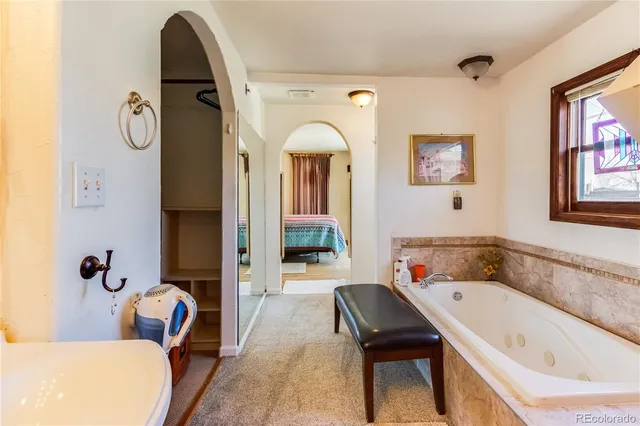 a bathroom with a tub and a window