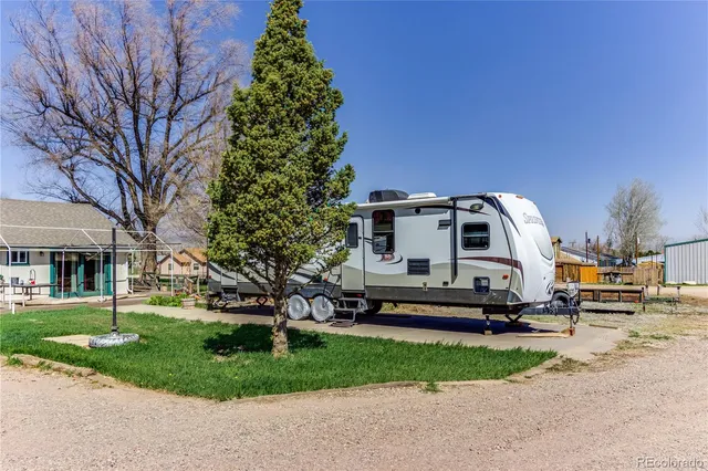 a white house with a tree in the background
