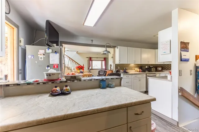a kitchen with a sink appliances and cabinets