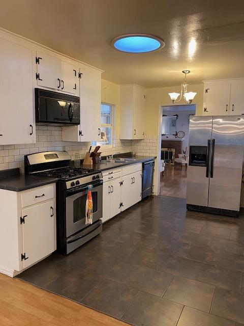 212 Iris Drive Salinas, CA 93906 - Photo 4 of 8 a kitchen with stainless steel appliances a stove a sink and a microwave