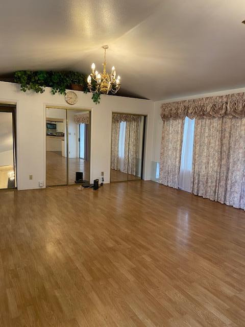 212 Iris Drive Salinas, CA 93906 - Photo 6 of 8 an empty room with chandelier fan and windows