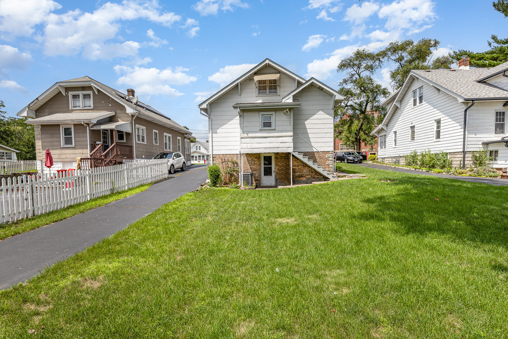 2723 Indiana Avenue Lansing, IL 60438 - Photo 1 of 18 a front view of a house with a yard and potted plants