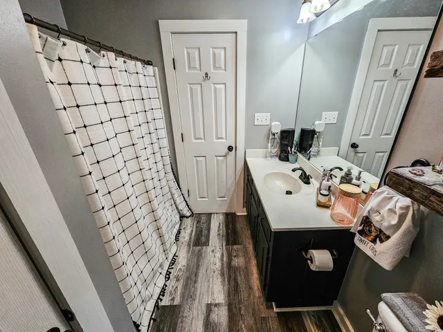 a bathroom with a sink a toilet and a mirror
