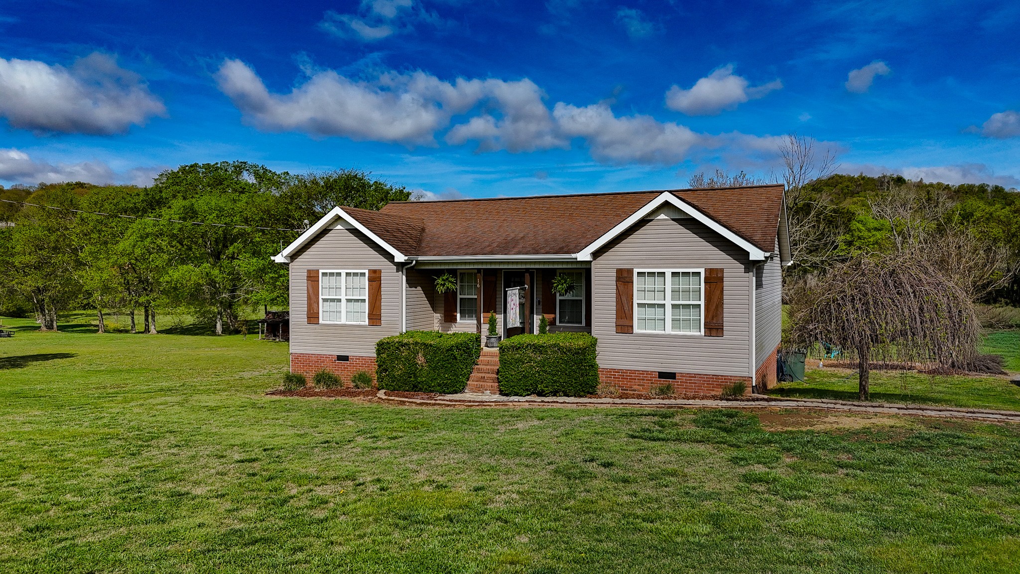 16 Volunteer Road Petersburg, TN 37144 - Photo 2 of 41 a front view of a house with a yard and garage