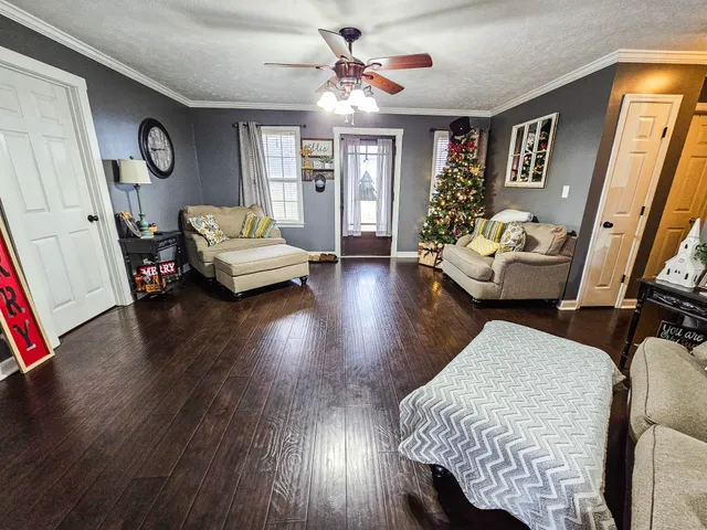 a living room with furniture and a wooden floor