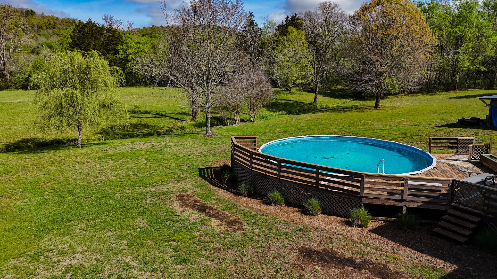 16 Volunteer Road Petersburg, TN 37144 - Photo 40 of 41 a view of a swimming pool with lawn chairs under an umbrella