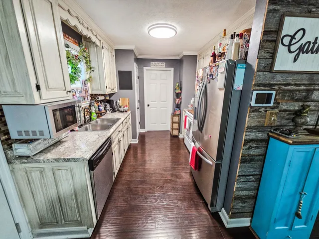 a kitchen with stainless steel appliances granite countertop a refrigerator a stove and a refrigerator