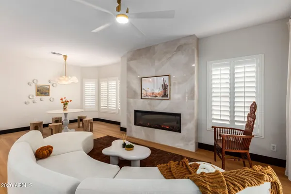 a dining room with wooden floor a chandelier a wooden table and chairs