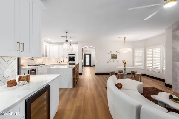 a large kitchen with a sink stainless steel appliances and cabinets
