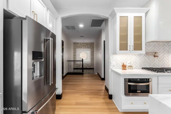 a kitchen with stainless steel appliances a stove a sink and a microwave