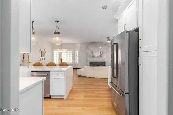 a kitchen with a stove a refrigerator and a sink
