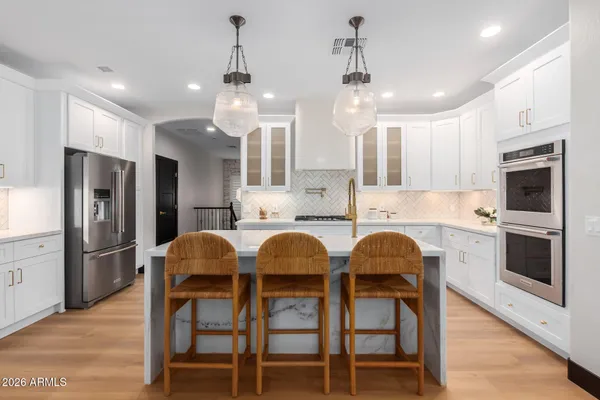 a kitchen with granite countertop a sink stove and cabinets