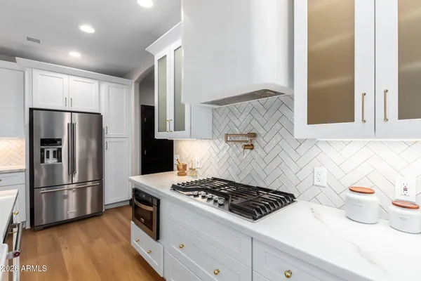 a spacious bedroom with a bed a couch and a large window