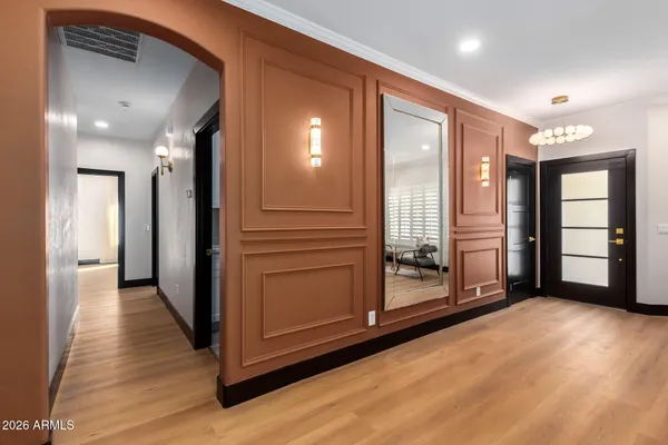 a view of a hallway with wooden floor and closet