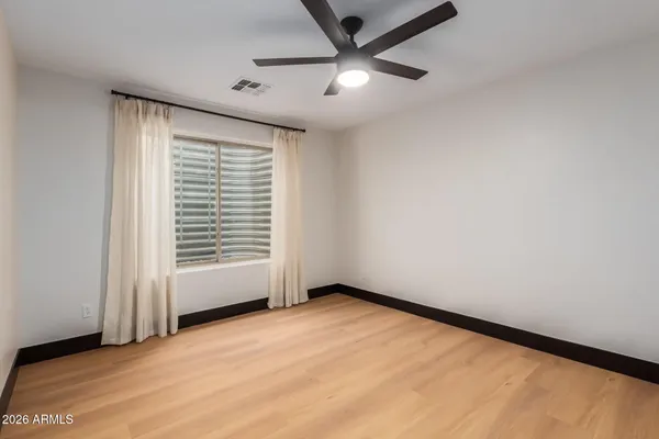 a living room with furniture a dining table and chairs with wooden floor