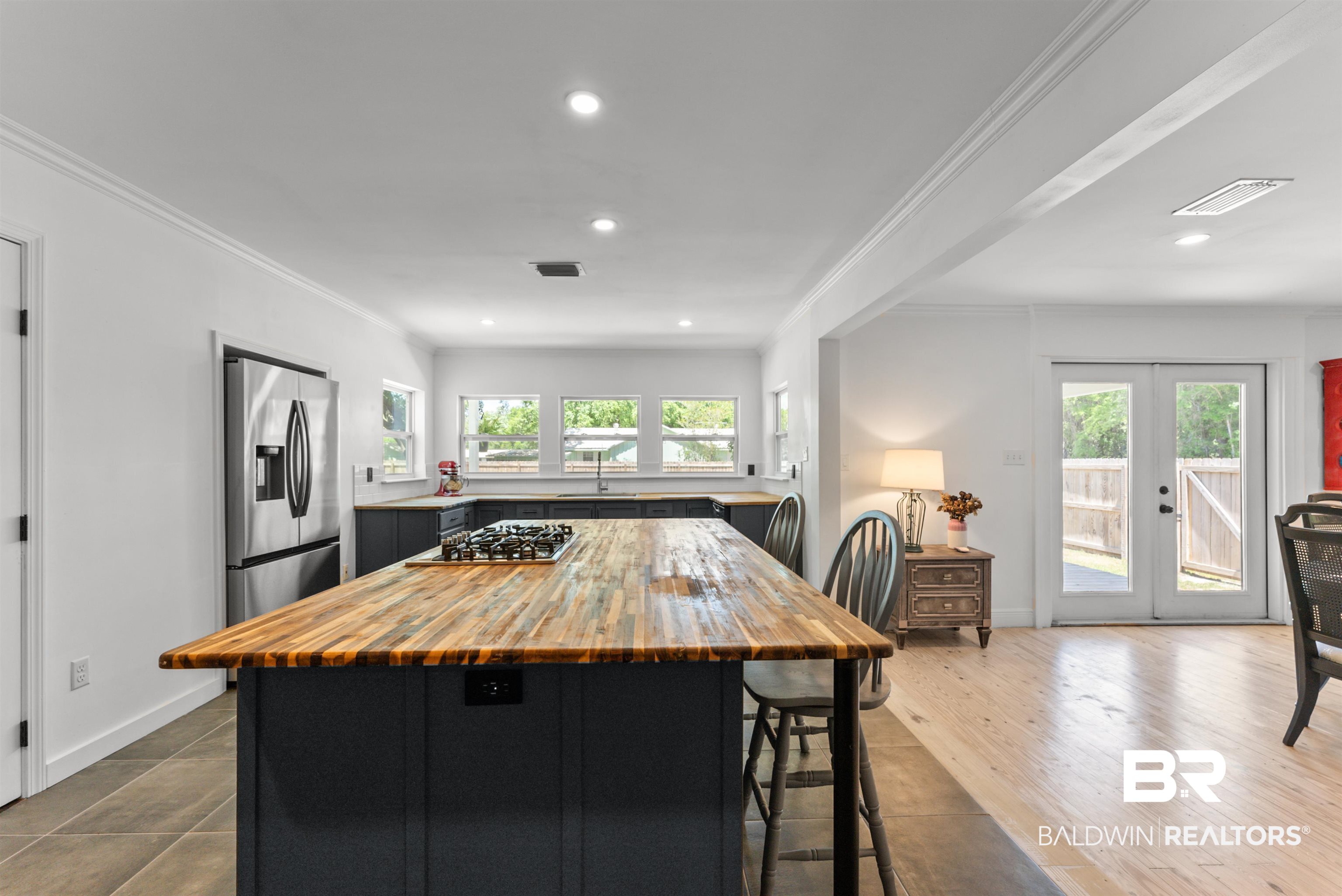6447 Bemis Lane Bon Secour, AL 36511 - Photo 15 of 62 Kitchen featuring a butcher block island with integrated cooktop, stainless steel refrigerator, dark cabinetry, and recessed lighting