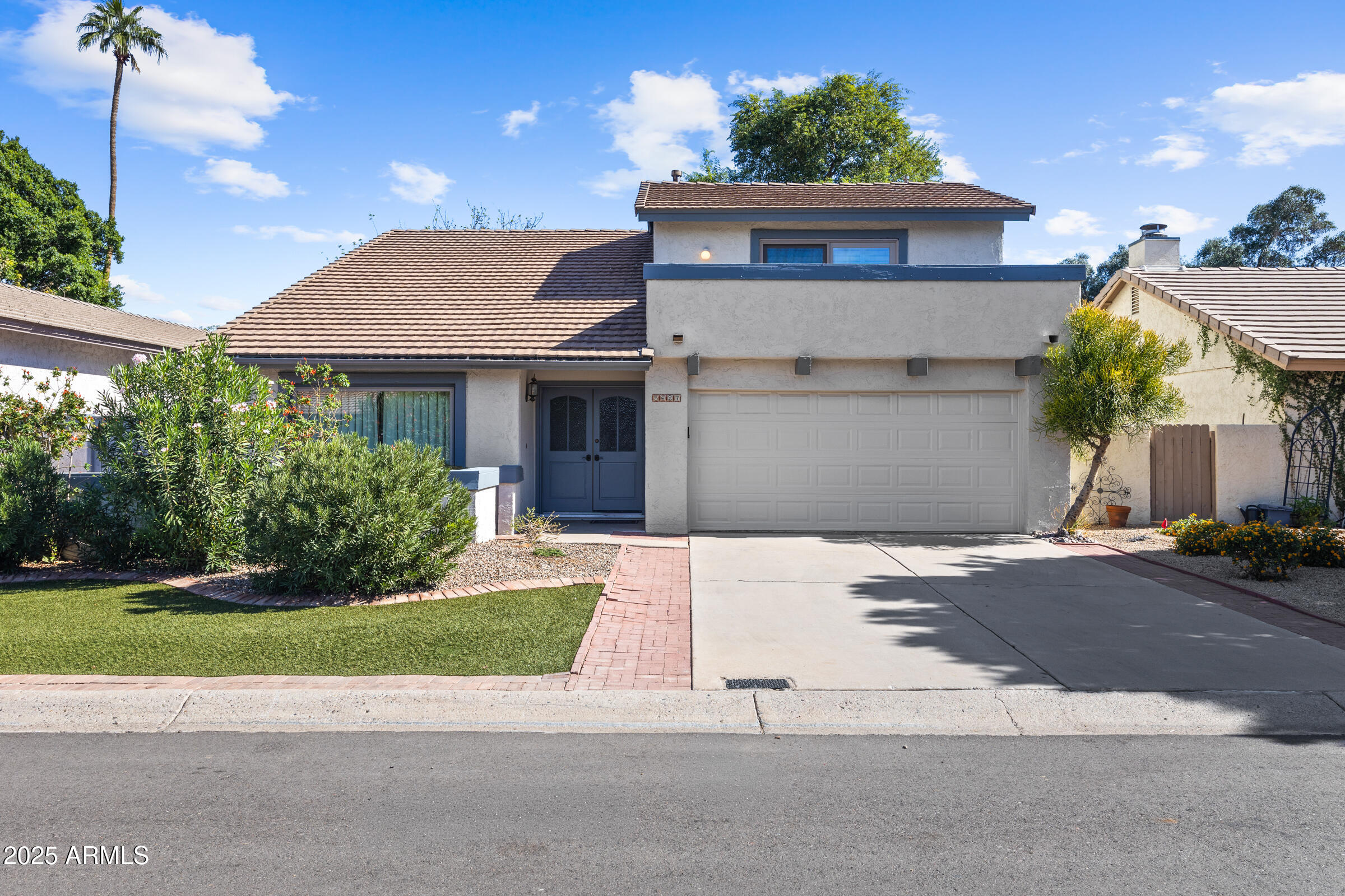 5627 South Crows Nest Road Tempe, AZ 85283 - Photo 53 of 93 a front view of a house with a yard and potted plants