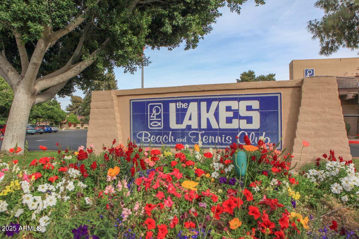 5627 South Crows Nest Road Tempe, AZ 85283 - Photo 68 of 93 a sign that is in front of flowers